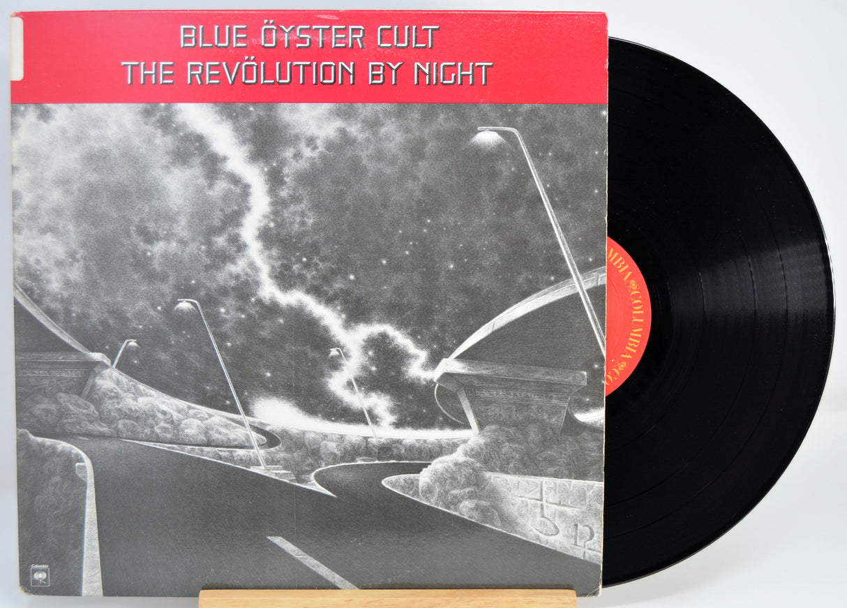 Vinyl record with 'Blue Öyster Cult' album cover showing a red label and black and white design.