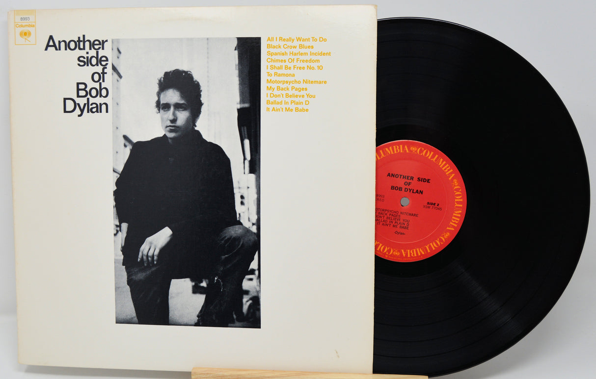 Vinyl record and cover featuring Bob Dylan with a black and white photo and red label.