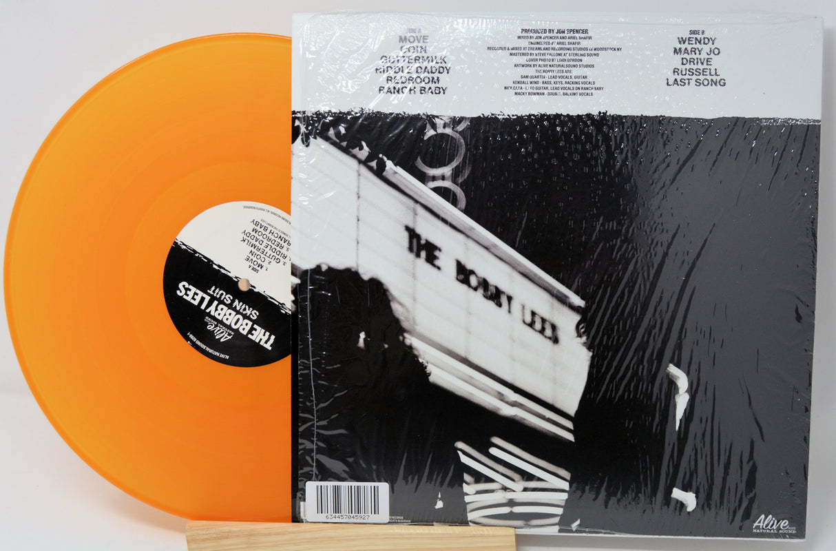 Orange vinyl record with a black and white album cover featuring a boat.