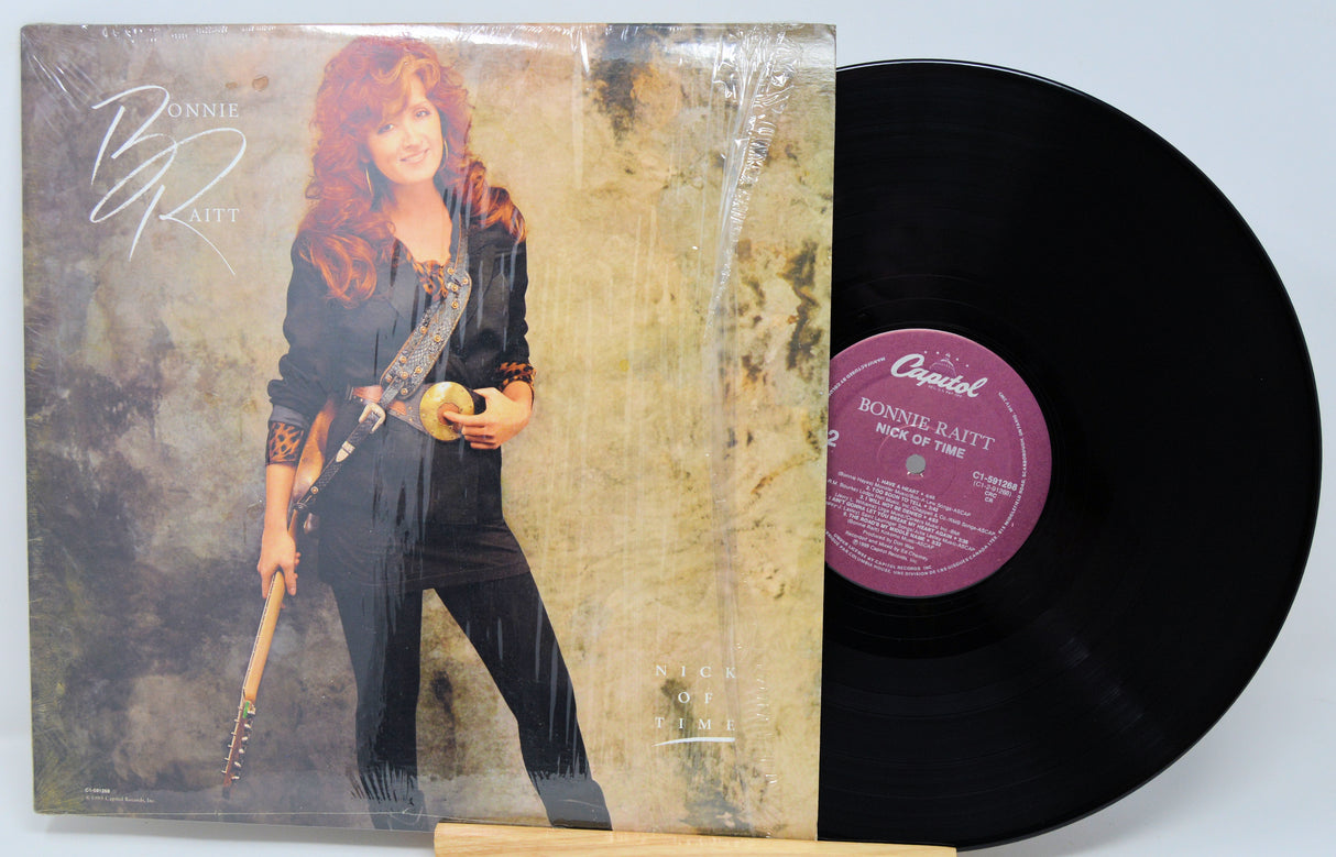 Vinyl record with orange cover featuring a silhouette of a couple and text 'Emotions'.