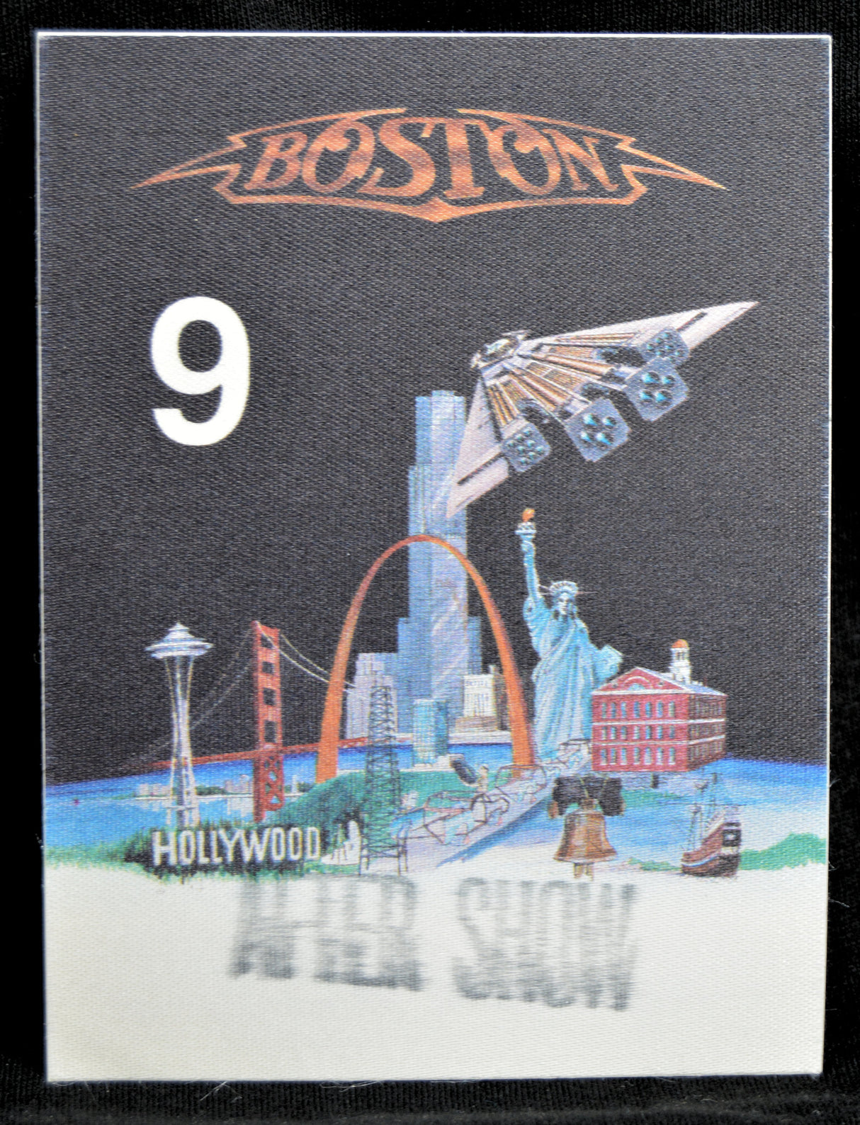 Backstage pass with 'Boston' logo, number 9, and cityscape illustration on a black border.