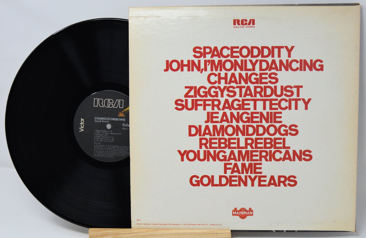 Vinyl record with cover displaying album tracklist on a light gray background