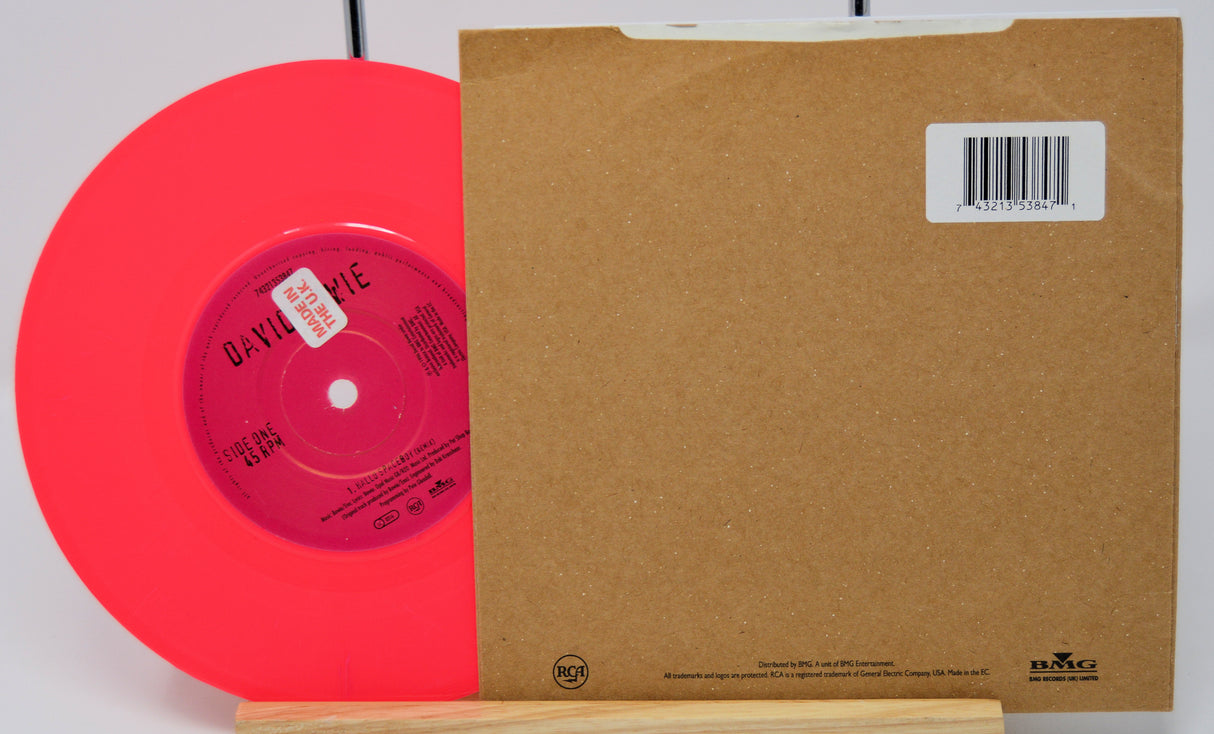 Red vinyl record with a brown sleeve on a white background