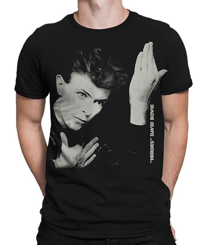 Black t-shirt with a graphic of a person with hands pressed together, worn by a person.