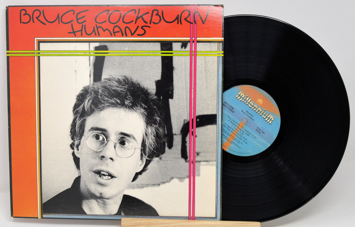 Vinyl record with cover featuring a person's face and album title 'Humans' by Bruce Cockburn.