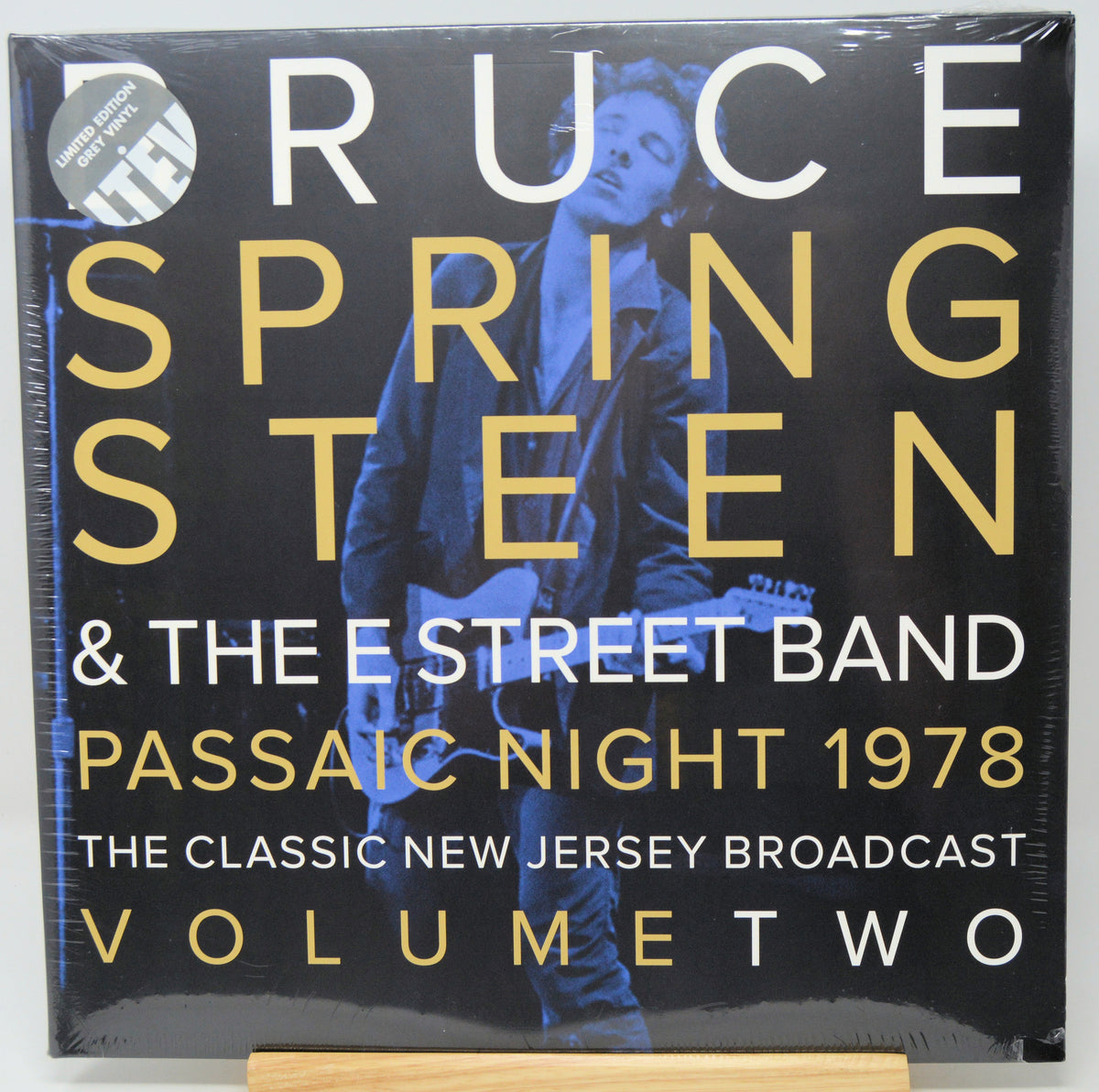 Ruce Springsteen & The E Street Band 'Passaic Night 1978' vinyl record cover, Volume Two, shown in its shrink wrap with a gold display block at the bottom.