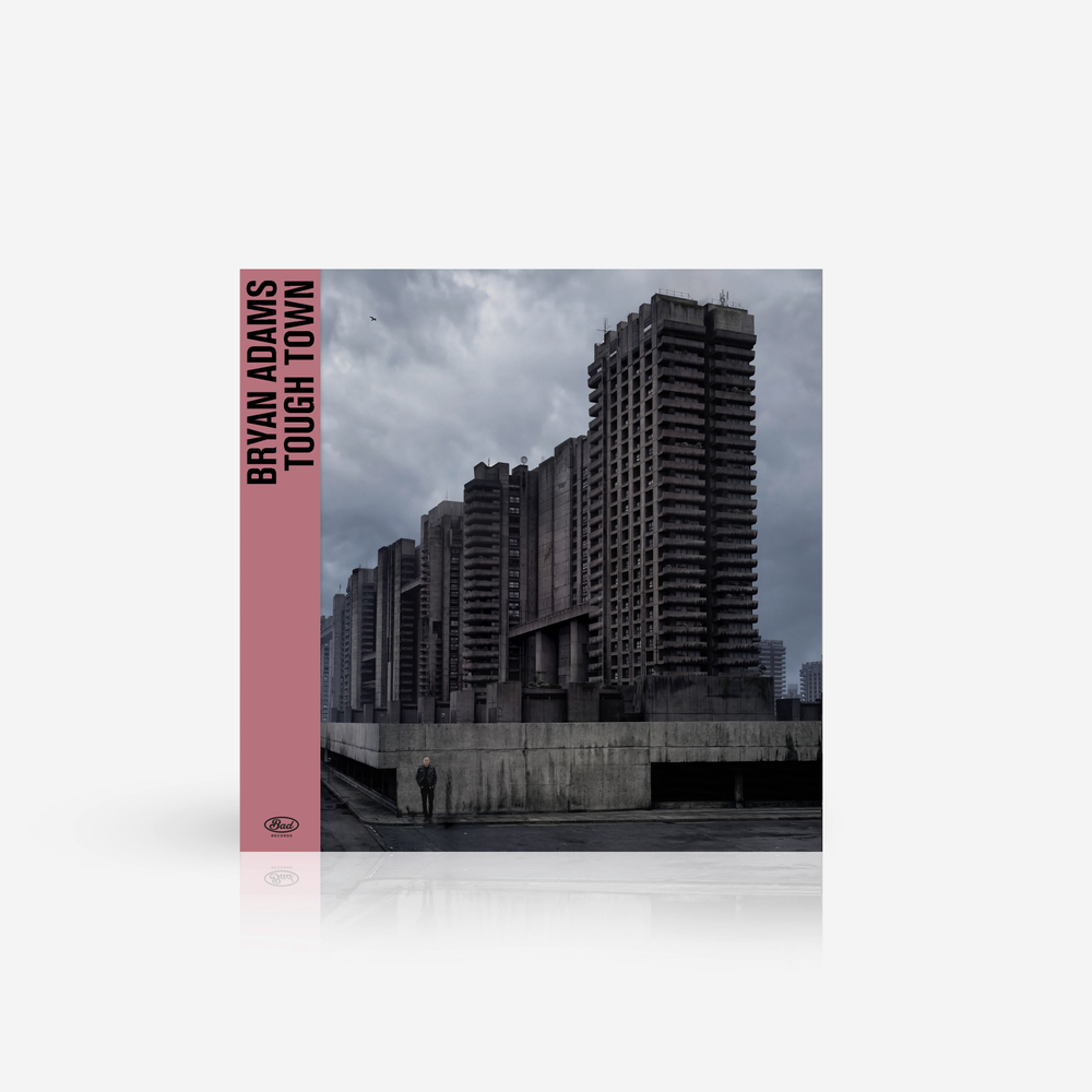 Vinyl record cover of 'Tough Town' by Bryan Adams with a cityscape background