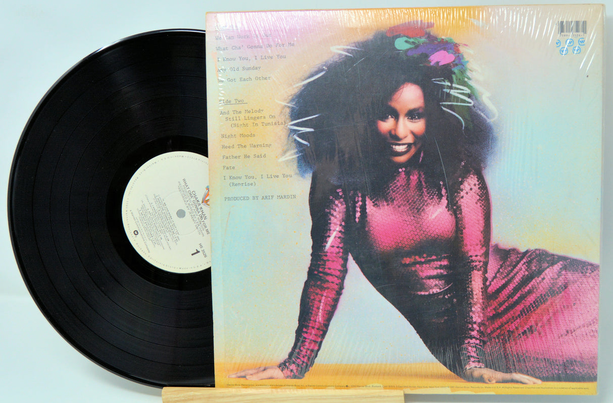 Vinyl record with a colorful cover featuring a person in a pink dress.