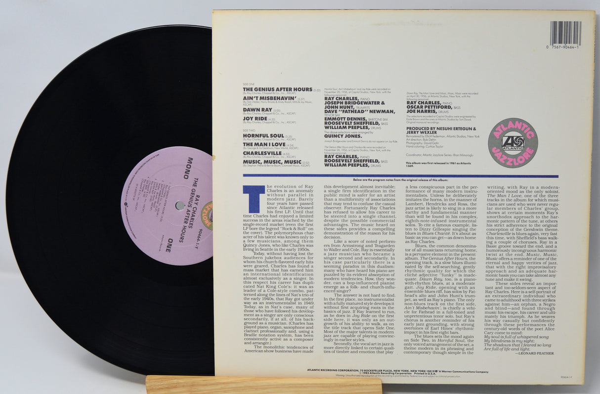 Vinyl record with text and a purple label on a white background