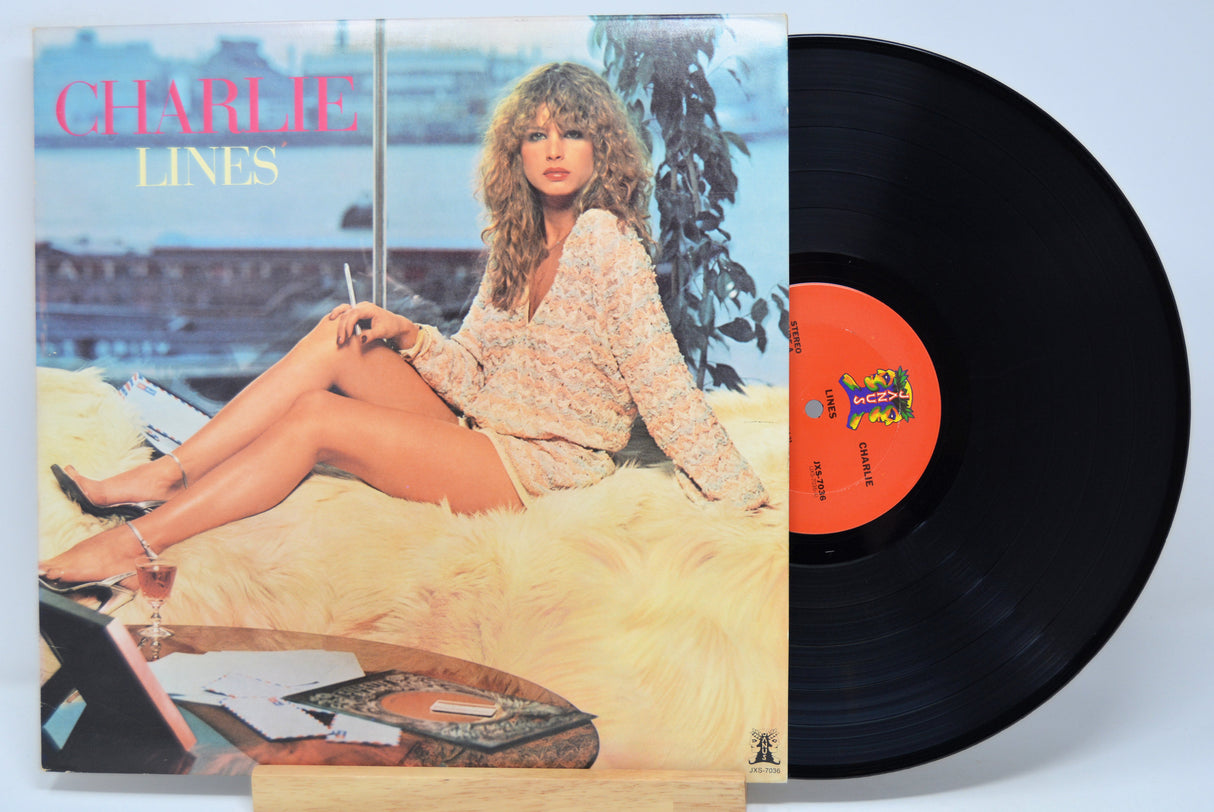 'Charlie Lines' Vinyl record with cover featuring a woman sitting on a couch by a window.