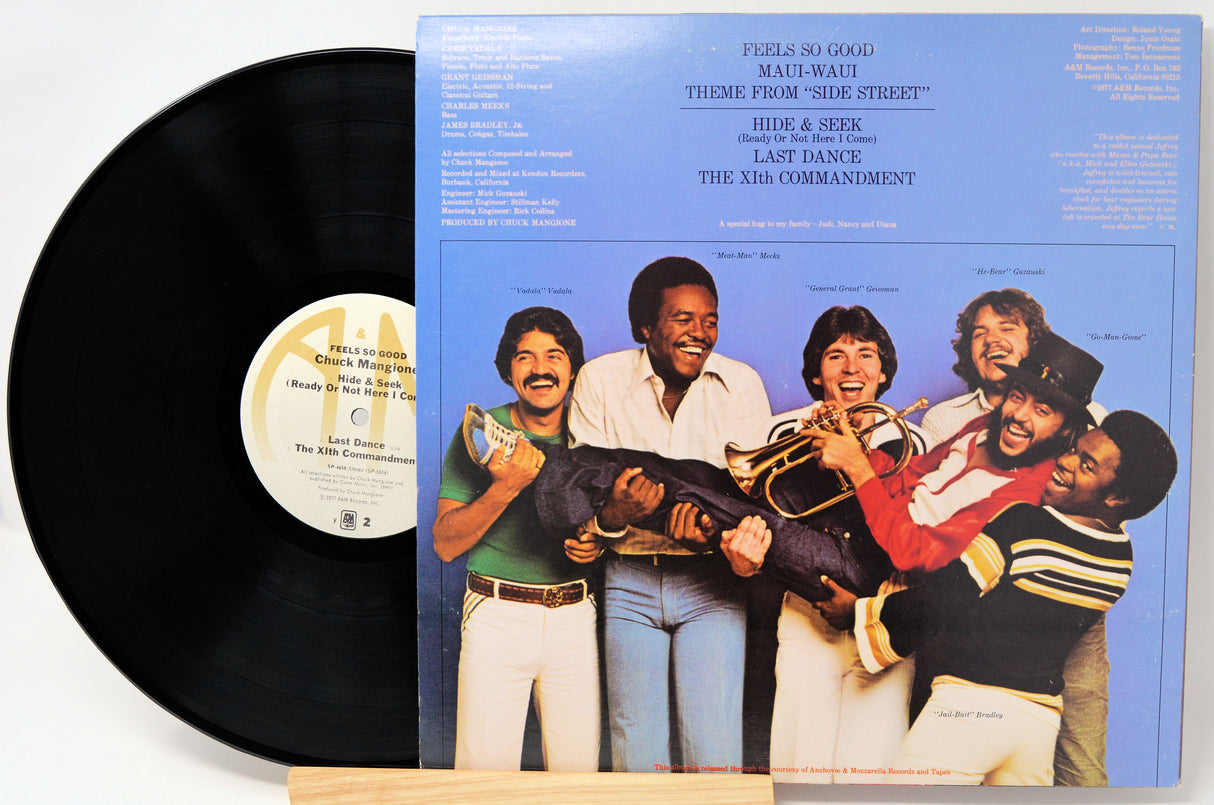 Vinyl record with cover featuring a group of people and text on a white background