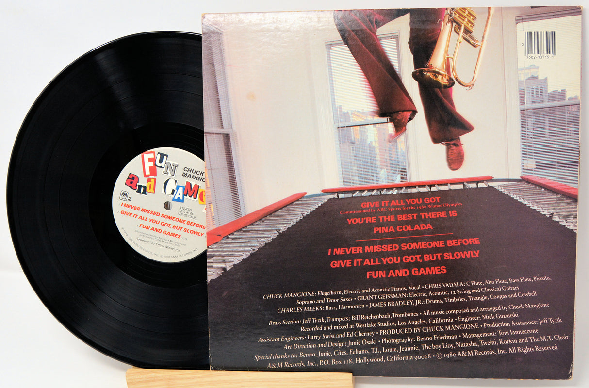 Vinyl record with cover featuring a person playing a trumpet, on a white background