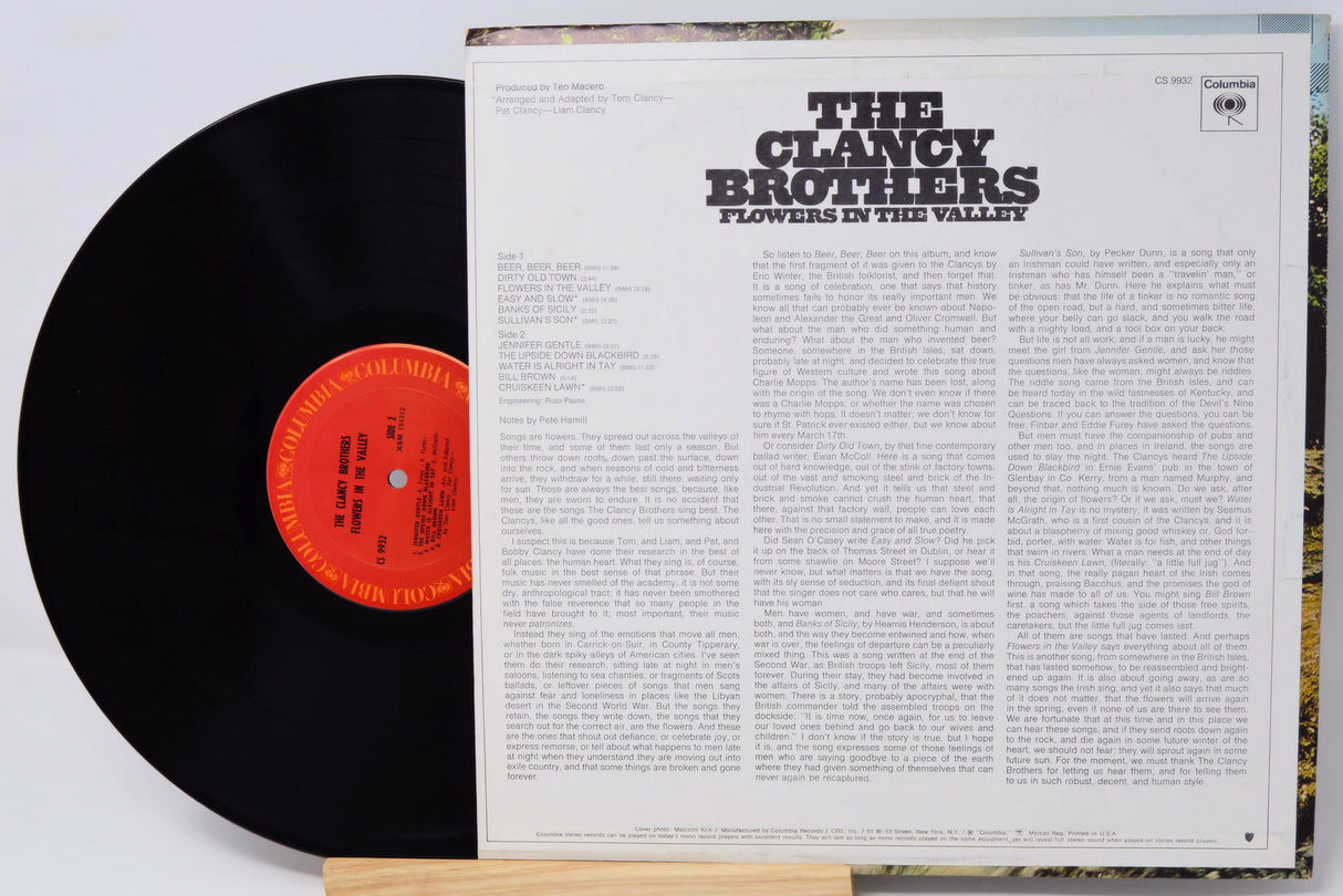 Vinyl record with cover displaying 'The Clancy Brothers' album titled 'Flowers in the Valley'.