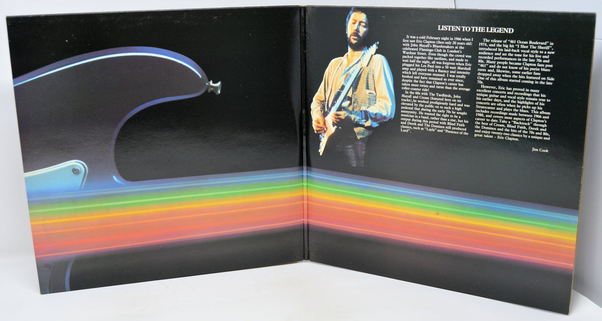 Album cover with a rainbow stripe and a person holding a guitar.