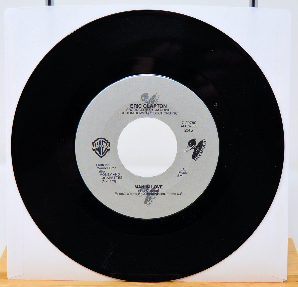 Vinyl record with a white label featuring Eric Clapton's name on a white background