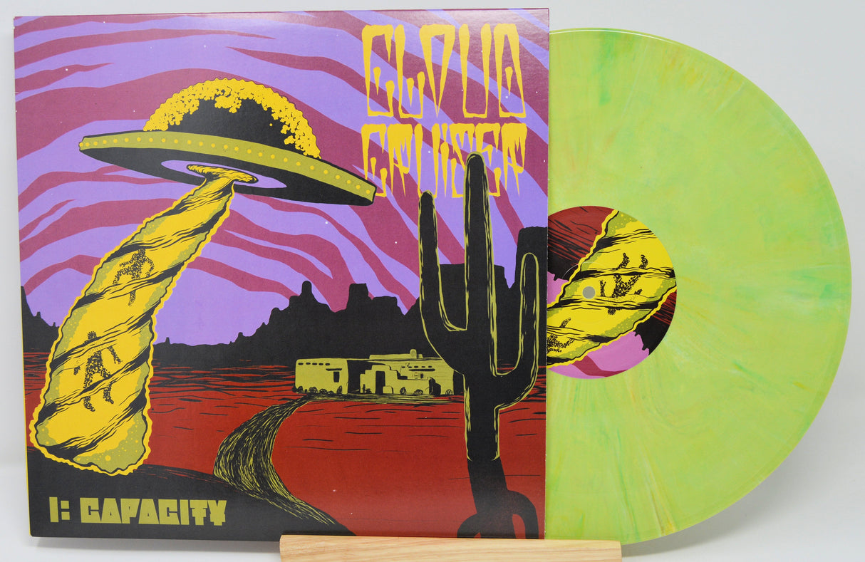 Front cover artwork of Cloud Cruiser I: Capacity Alien Blood vinyl LP with UFO and Southwestern landscape