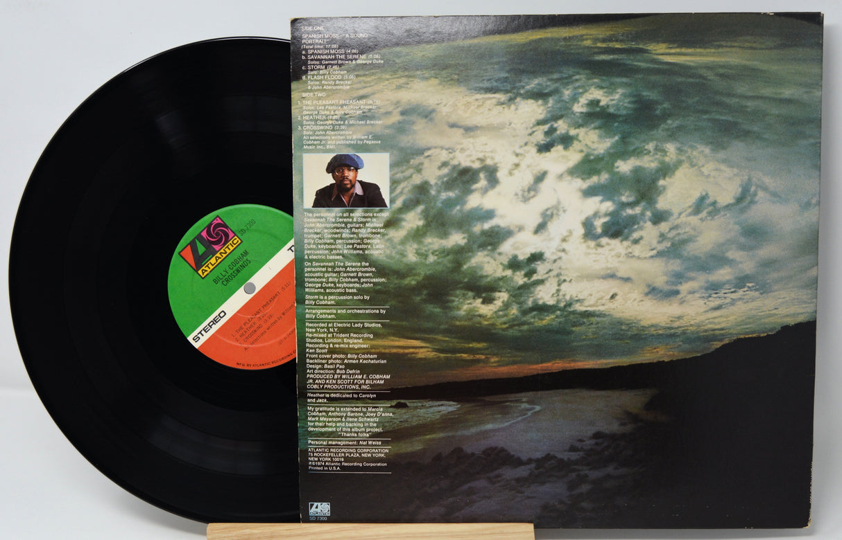 Vinyl record with a scenic cover and green label on a white background