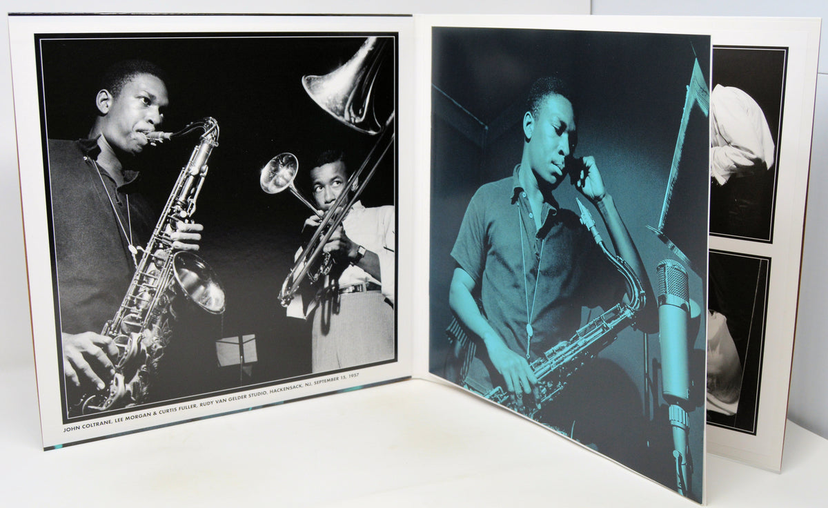 A set of black and white photographic prints displayed in an open photo album or binder. The prints feature jazz musicians playing saxophones and trumpets, with one print rendered in a strong blue-green tint.
