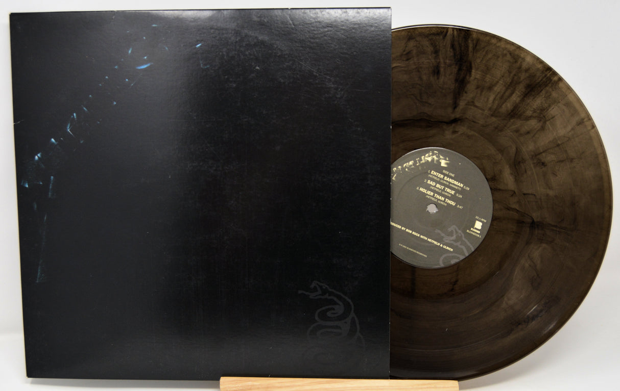 Vinyl record with a black cover on a white background