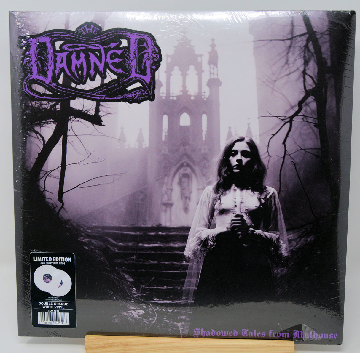 Vinyl record cover with a gothic design featuring a person in a hooded garment and a cathedral-like structure.