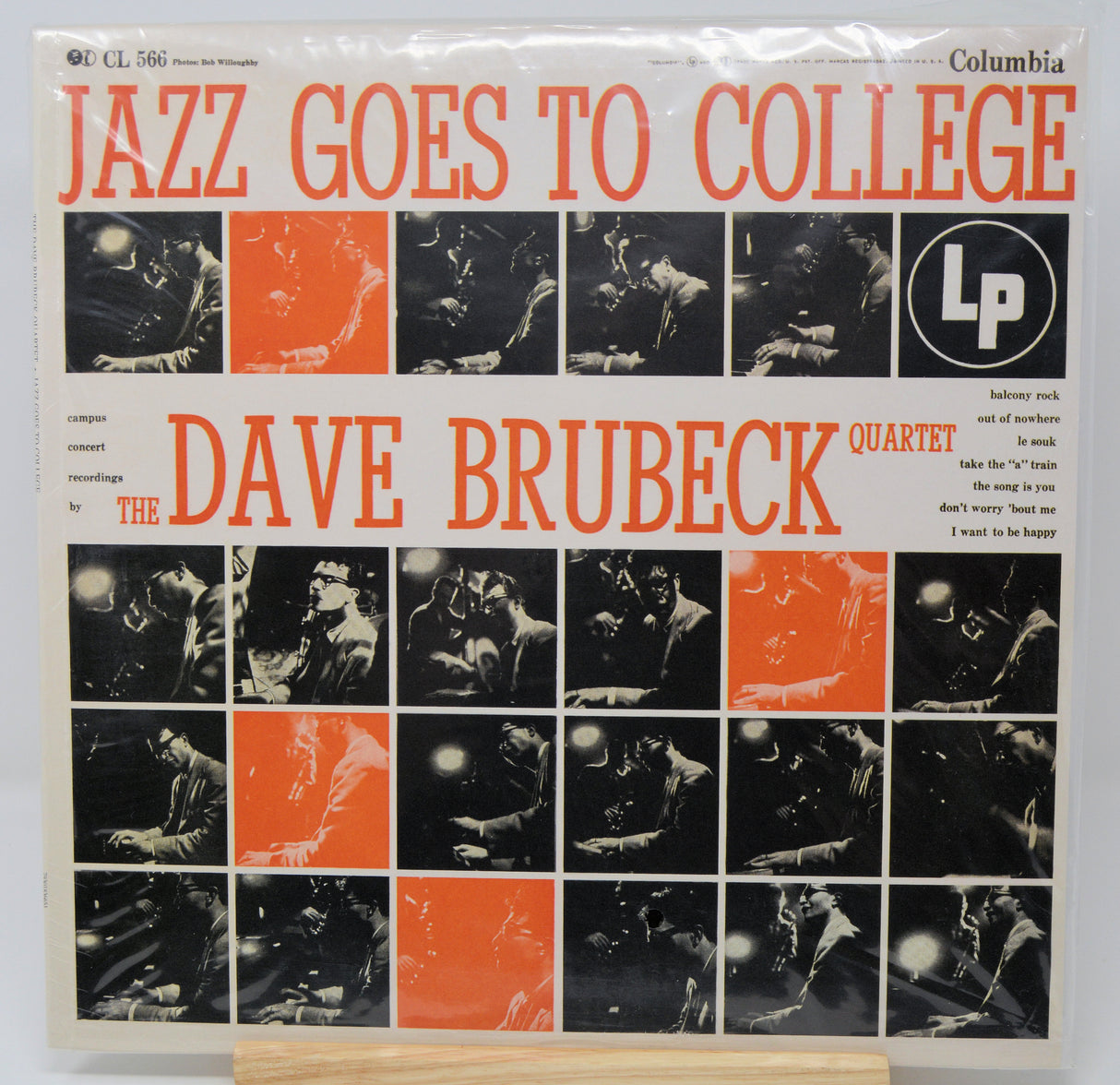 The Dave Brubeck Quartet's 'Jazz Goes to College' Columbia LP album cover, presented flat on a light-colored surface. The cover features a grid of black-and-white photos with orange accents and bold orange typography.