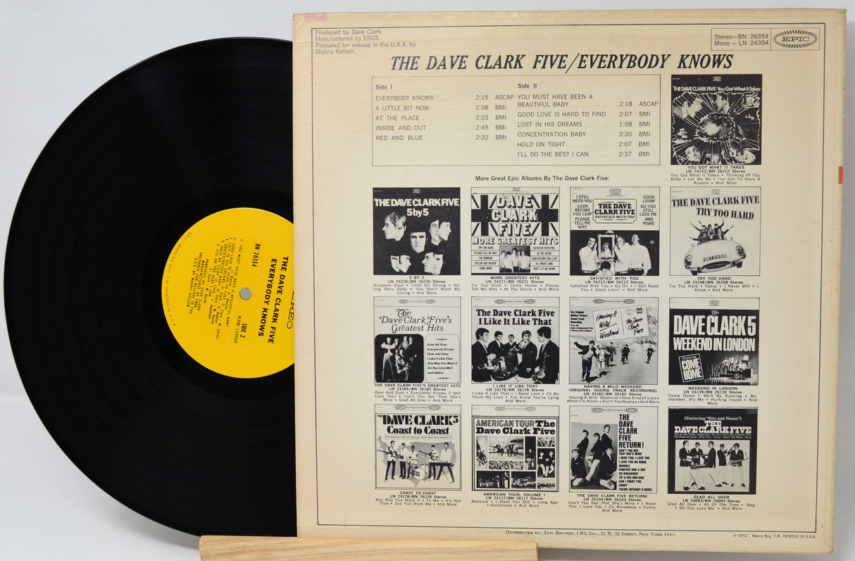 Vinyl record with yellow label and cover featuring black and white images and text.