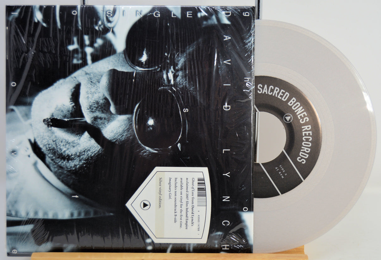 David Lynch silver Vinyl record Ghost Of Love with black and white cover featuring a person's face, on a white background.