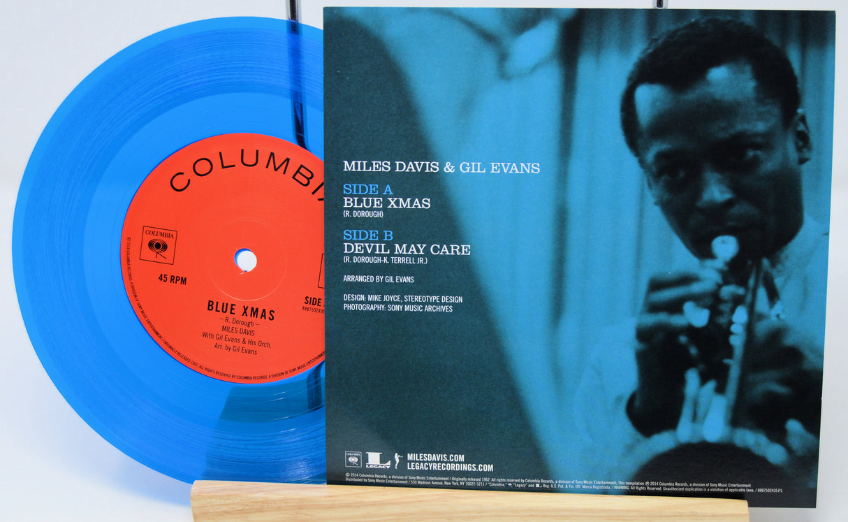 Vinyl record with blue label and cover featuring Miles Davis and Gil Evans on a white background