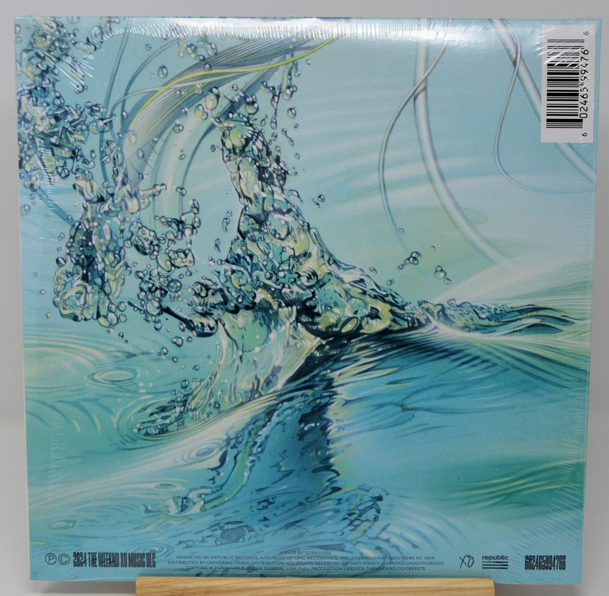 Abstract water splash with vibrant reflections from The Weeknd's Dawn FM vinyl album art