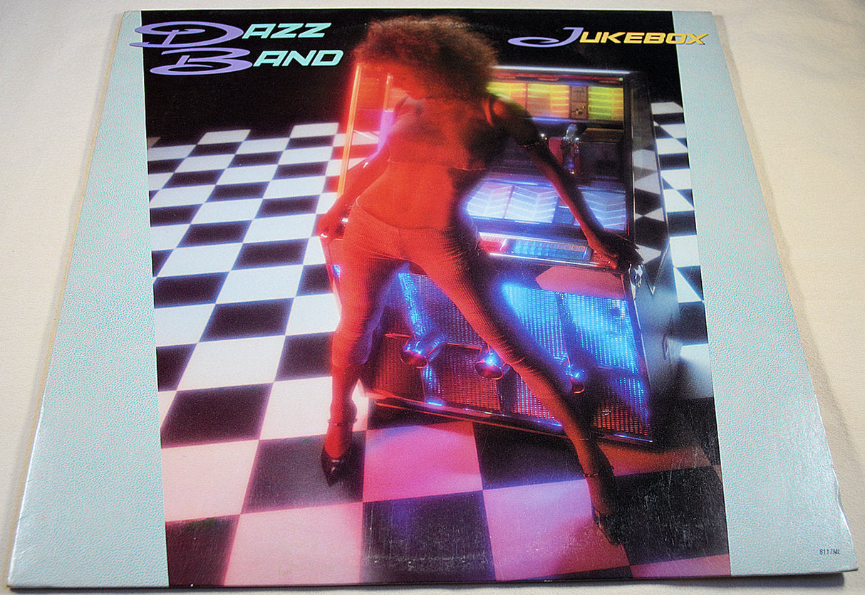 Front cover of Dazz Band Jukebox album with neon-lit jukebox and model