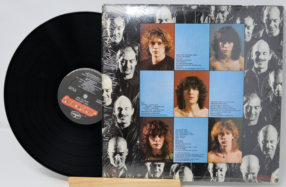 Vinyl record with a cover featuring multiple faces and text on a white background