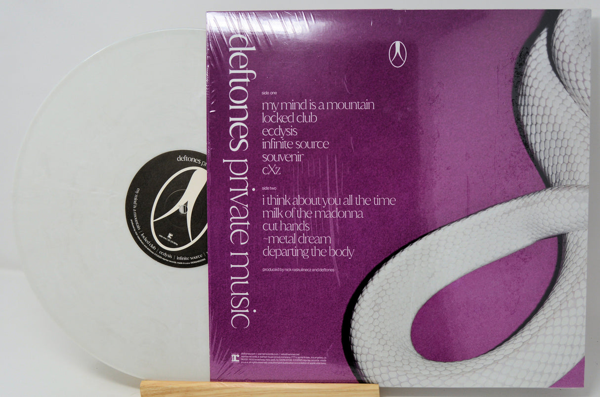 Back cover of Deftones Private Music LP showing tracklist on purple background with a white snake illustration and translucent white vinyl.