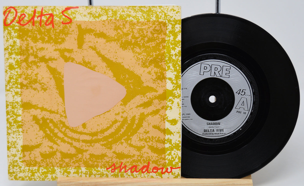 Vinyl record with cover titled 'Shadow' by Delta 5 on a white background