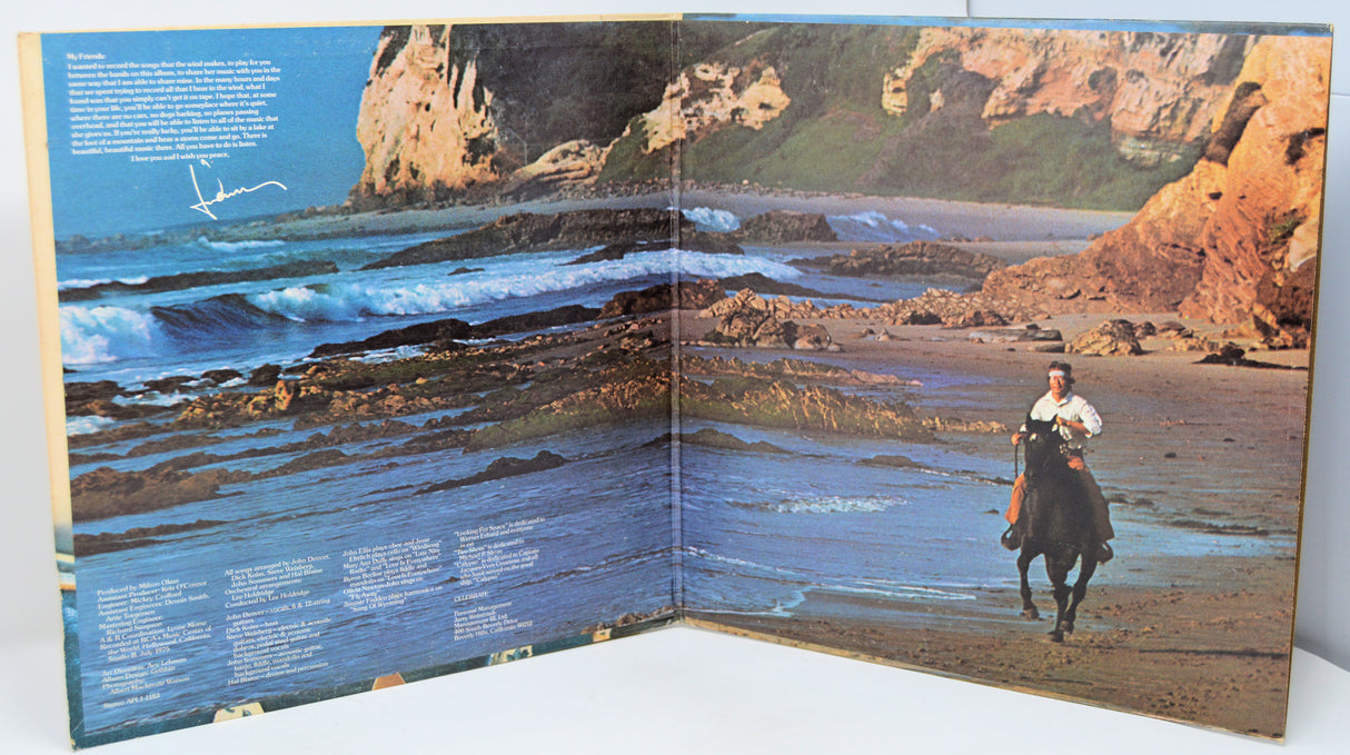 Open book showing a scenic landscape with cliffs and a person on horseback.