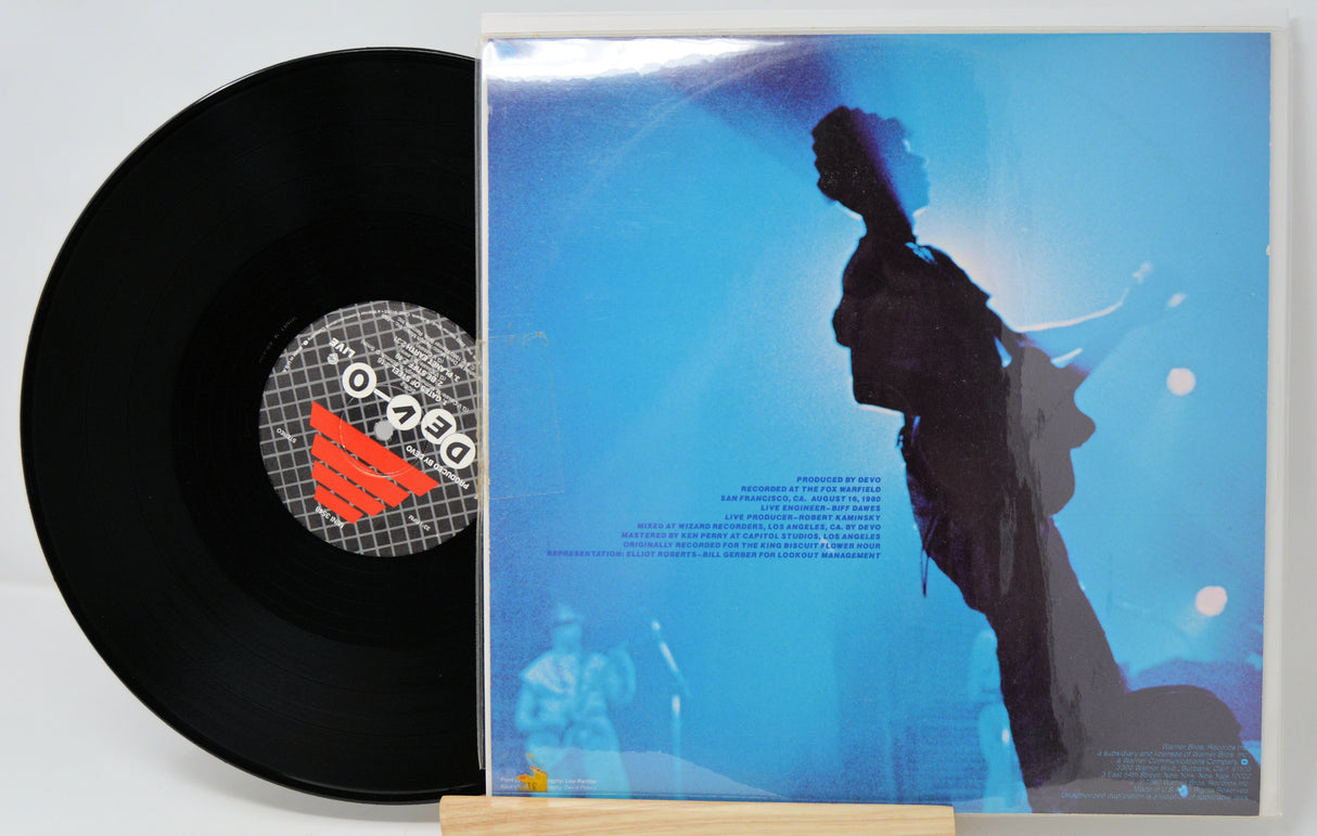Vinyl record with a cover featuring a silhouette of a person against a blue background.