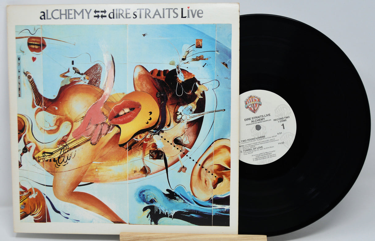 Vinyl record with colorful cover featuring artistic design and 'Alchemy Dire Straits Live' text.