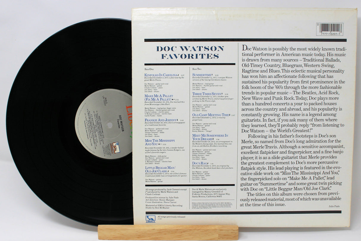 Back cover and vinyl record of Doc Watson Favorites album showing song list and artist biography