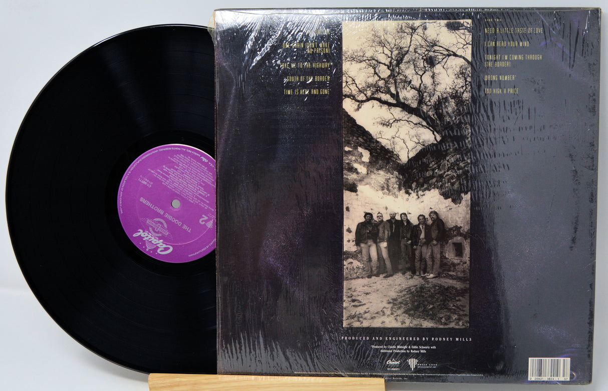 Vinyl record with a purple label and its cover on a white background