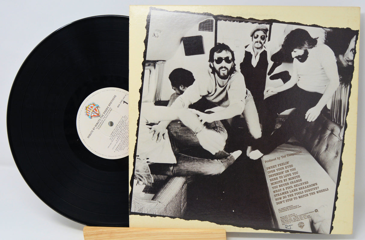 Vinyl record with a black and white photo of people on the cover