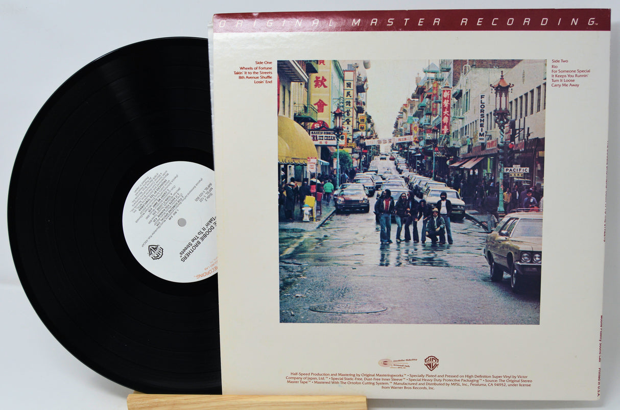 Vinyl record with cover featuring a street scene and 'Master Recording' text.