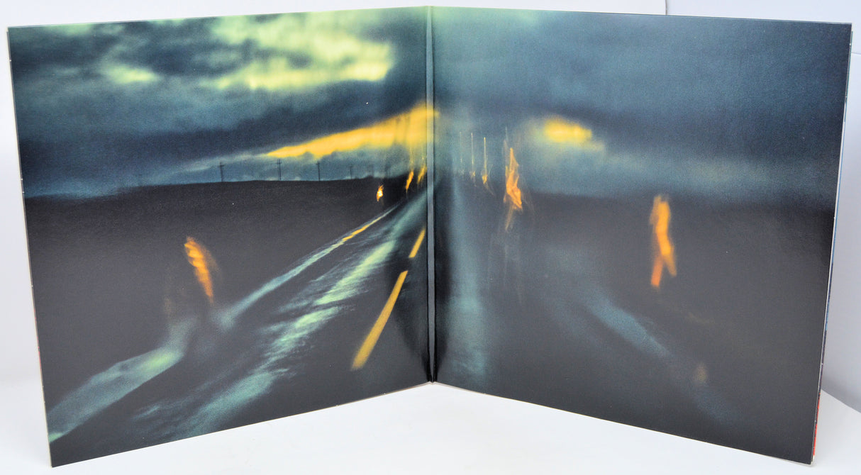 Open book showing a blurred image of a road with lights at night.