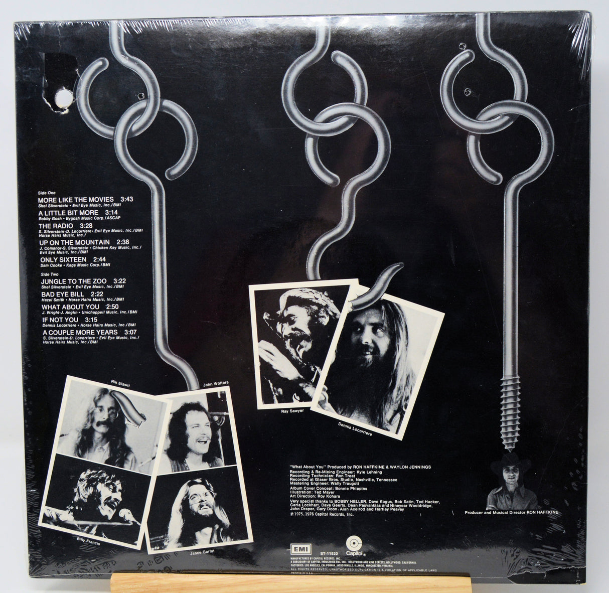Vinyl record sleeve with black and white photos and text on a dark background
