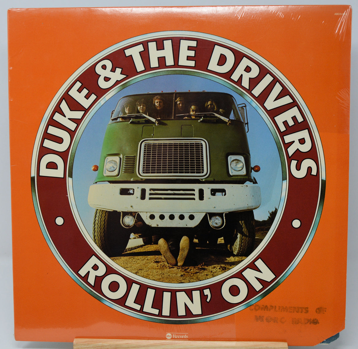 Vinyl record cover for 'Duke & The Drivers Rollin' On' with a green truck on an orange background