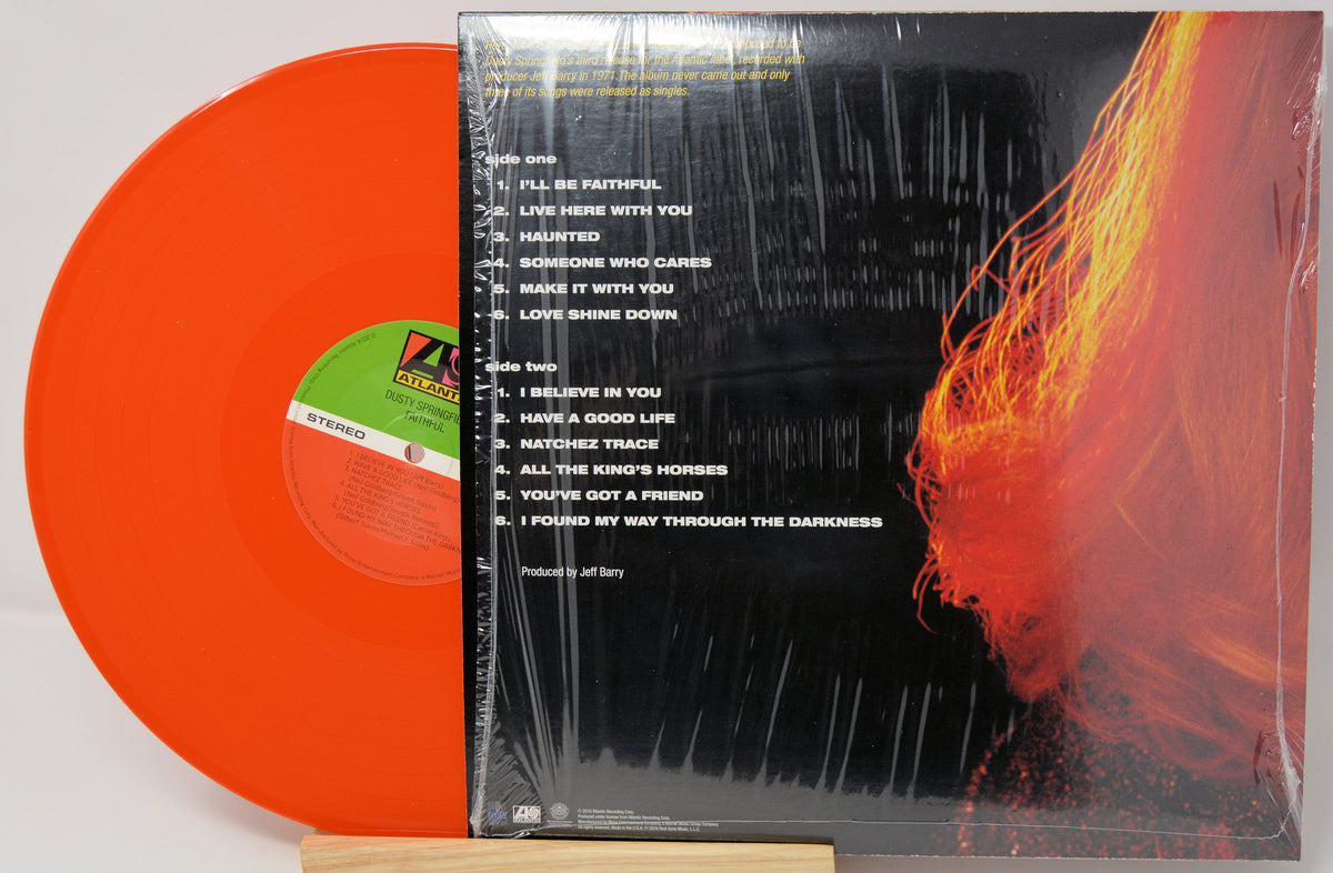 Jeff Barry's 'I'll Be Faithful' vinyl record LP shown with its black illustrated cover sleeve and a bright orange translucent record standing beside it.