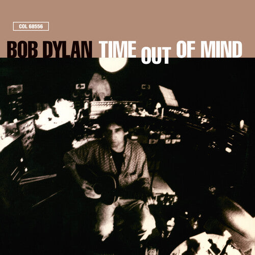 Album cover for 'Time Out of Mind' by Bob Dylan featuring a black and white photo of the artist in a recording studio.