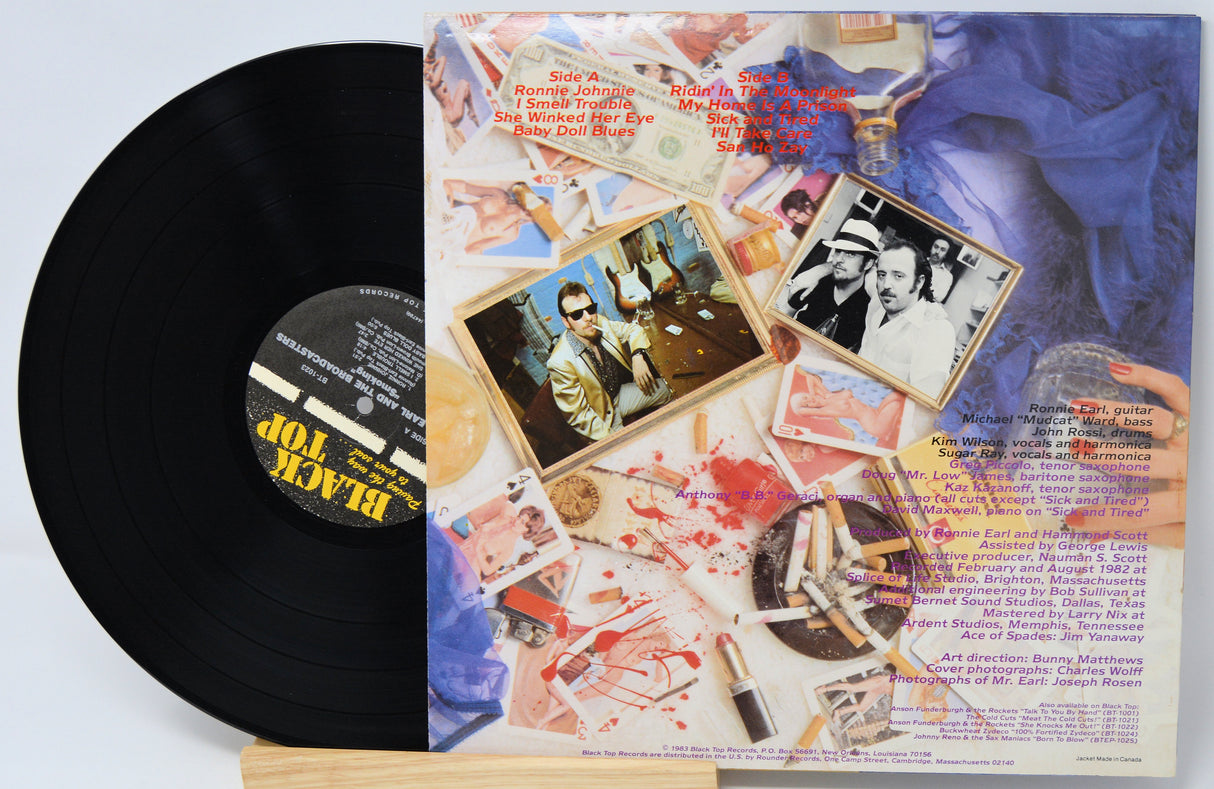Vinyl record with a colorful album cover featuring images and text.