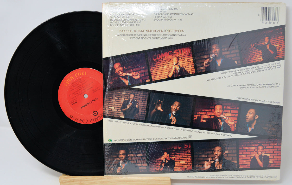 Vinyl record with a cover featuring images of a man and text on a white background