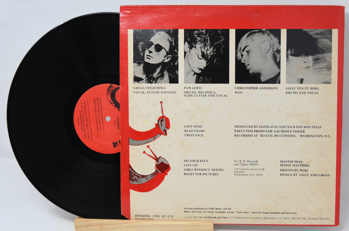 Vinyl record with red label and black disc on a white background