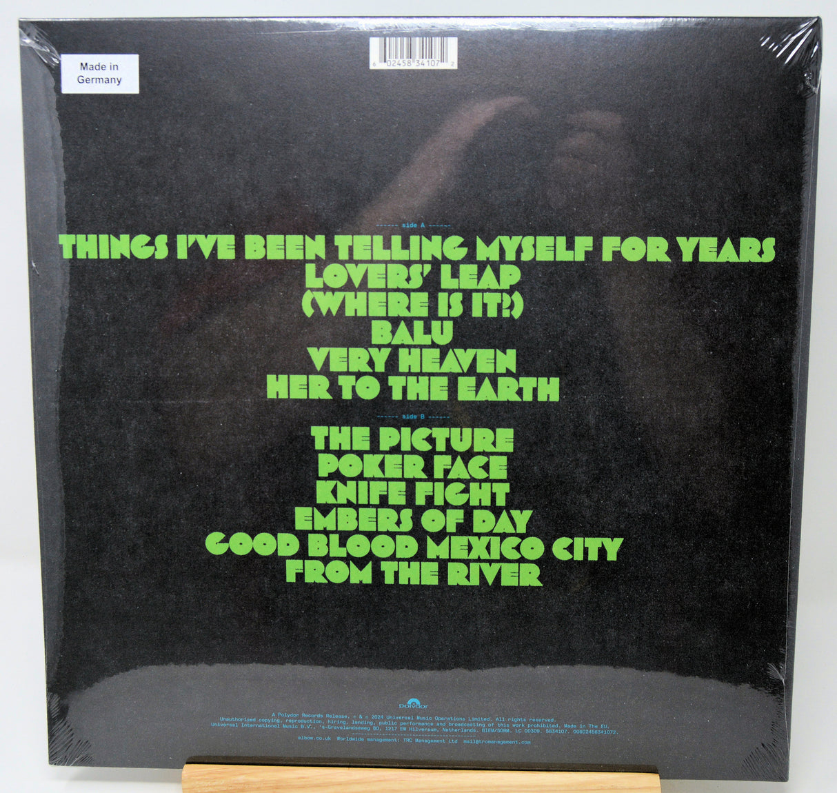 Vinyl record cover with green text on a black background