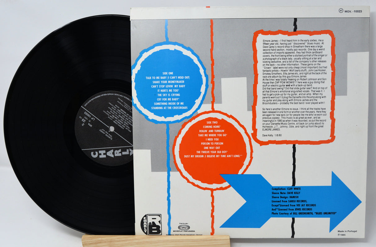 Vinyl record with a colorful album cover featuring geometric shapes and text.